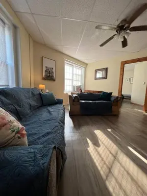 a living room with a couch and a ceiling fan at Comfy Apt near Guthrie RPH Sayre in Sayre