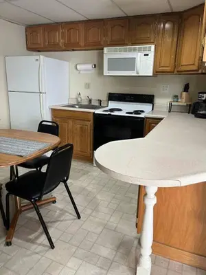 a kitchen with a table and a counter top at Comfy Apt near Guthrie RPH Sayre in Sayre