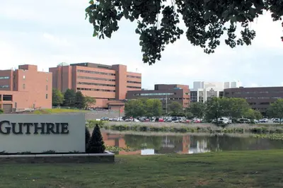 a city with a sign in front of a building at Comfy Apt near Guthrie RPH Sayre in Sayre