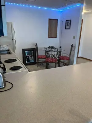 a kitchen with a stove and a table and chairs at Spacious Apt near Guthrie Packer in Sayre