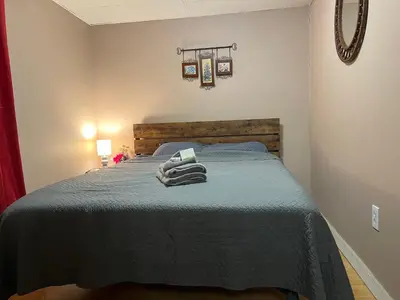 a bedroom with a bed with towels on it at Cozy Apt near BU, Lourdes, UHS in Johnson City