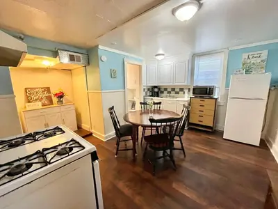 a kitchen with a table and a white stove top oven at Cheerful Studio short walk to UHS near Lourdes & BU in Johnson City