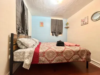 a small bedroom with a bed with a comforter at Cheerful Studio short walk to UHS near Lourdes & BU in Johnson City