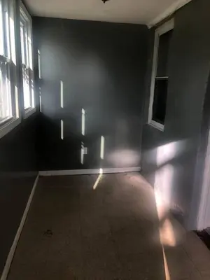 an empty room with windows and a dark wall at Cheerful Studio short walk to UHS near Lourdes & BU in Johnson City