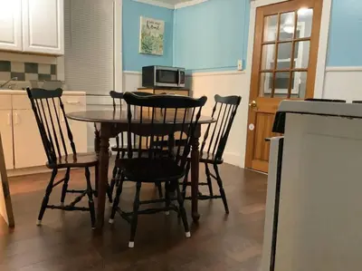 a kitchen with a table with chairs and a microwave at Cheerful Studio short walk to UHS near Lourdes & BU in Johnson City