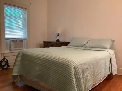 a bedroom with a bed and a window with a fan at Spacious Inviting Home by BU UHS & Guthrie in Johnson City