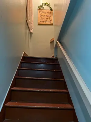 a set of stairs with a sign on the wall at Spacious 3 bed by Wilson, Lourdes Hospitals near Vestal in Johnson City