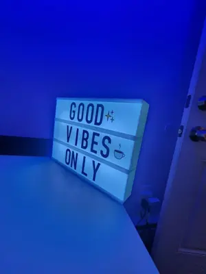 a blue room with a stack of boxes with good vibes on it at Zen Oasis Room in Newark