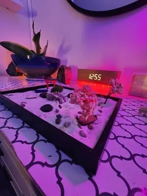 a room with purple lighting and a table with flowers at Zen Oasis Room in Newark