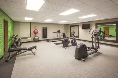 a gym with several treadmills and exercise equipment in a room at La Quinta by Wyndham Mechanicsburg - Harrisburg in Mechanicsburg