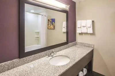 a bathroom with a sink and a mirror at La Quinta by Wyndham Mechanicsburg - Harrisburg in Mechanicsburg