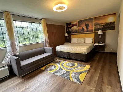 a bedroom with a bed and a couch at THE GOLFERS INN in Upper Darby