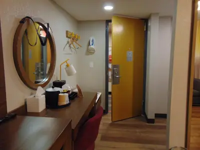 a room with a vanity with a mirror and a mirror at THE GOLFERS INN in Upper Darby