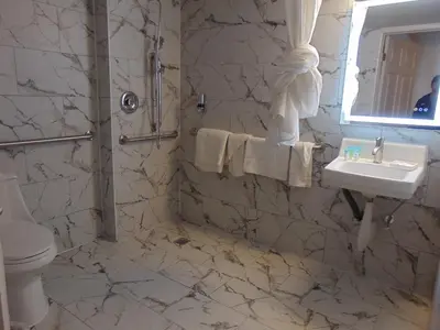 a white bathroom with a sink and a toilet at THE GOLFERS INN in Upper Darby