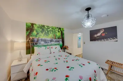 a bedroom with a bed and a painting on the wall at 2 Mi to Hersheypark Group Getaway with Deck in Hummelstown