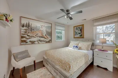 a bedroom with a bed and a ceiling fan at 2 Mi to Hersheypark Group Getaway with Deck in Hummelstown