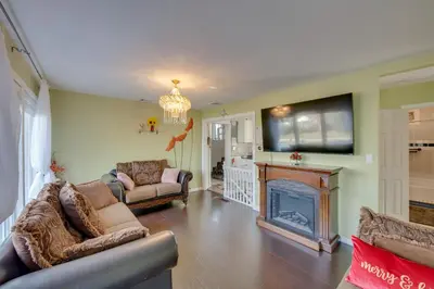 a living room with a fireplace and a tv at 2 Mi to Hersheypark Group Getaway with Deck in Hummelstown