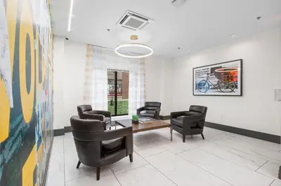 a living room with chairs and a table in a room at Modern 2BR 2BA Condo Sleeps 8 with Gym Laundry 20 Min to NYC in Jersey City
