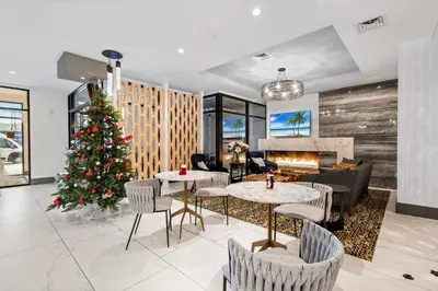 a christmas tree in a living room with a fireplace at Modern 2BR 2BA Condo Sleeps 8 with Gym Laundry 20 Min to NYC in Jersey City