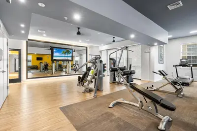 a gym with several treadmills and cardio machines at Modern 2BR 2BA Condo Sleeps 8 with Gym Laundry 20 Min to NYC in Jersey City
