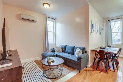a living room with a couch and a table at Comfy Bayonne Townhome about 11 Mi to NYC Attractions in Bayonne