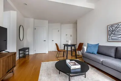a living room with a couch and a table at FiDi 1br w fitness center nr freedom tower NYC-1340 in New York