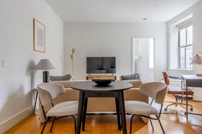 a living room with a table and chairs at FiDi 1br w game room resident-only speakeasy NYC-1346 in New York