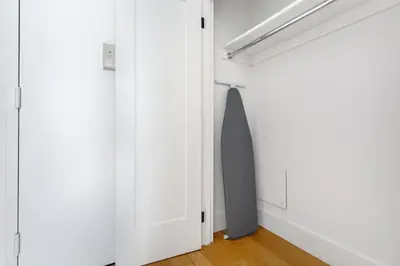 a closet with white walls and a gray door at FiDi 1br w gym doorman lounge nr park NYC-1344 in New York