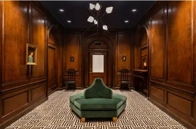a green chair in a room with wooden walls at FiDi 1br w gym doorman lounge nr park NYC-1344 in New York