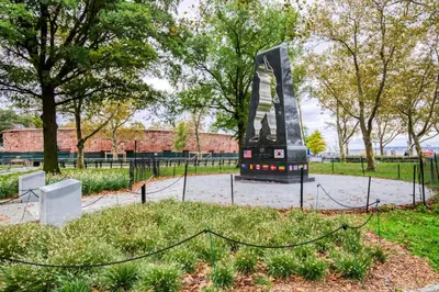 a sculpture in a park with trees and a fence at FiDi 1br w gym doorman lounge nr park NYC-1344 in New York