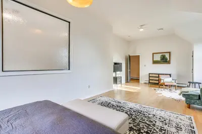 a bedroom with a bed and a living room at Secluded Kerhonkson Retreat with Deck and Views! in Sundown