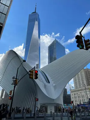 a large white building in a city with tall buildings at moon lotus abode(\u6708\u84ee\u5c45) in New York