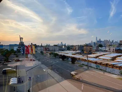 a view of a city street with buses at moon lotus abode(\u6708\u84ee\u5c45) in New York