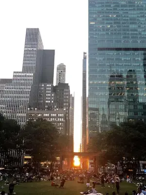 a group of people in a park in a city at moon lotus abode(\u6708\u84ee\u5c45) in New York