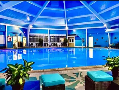 a large swimming pool with a blue ceiling at Cozy cottage in the heart of pocono in Long Pond