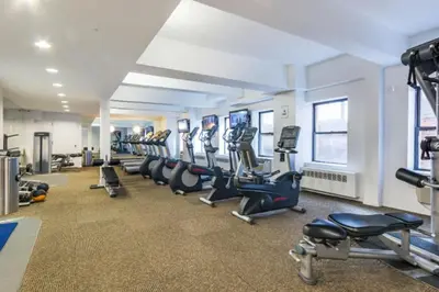 a gym with a row of treadmills and machines at Hudson Yards 1br w gym wd nr penn station NYC-1308 in New York