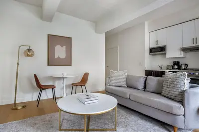 a living room with a couch and a table at Hudson Yards 1br w gym wd nr penn station NYC-1308 in New York
