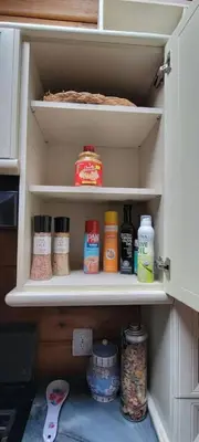 a cabinet filled with lots of spices and condiments at Comfy Log Cabin Family & Pet Kind by State & Waterparks! in Tobyhanna