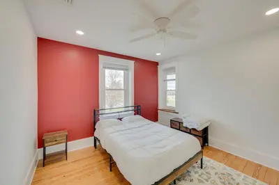 a bedroom with two beds and a red wall at 15 Mi to Amish Village Cozy Lancaster Apt! in Lancaster