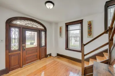 an empty room with a wooden door and stairs at 15 Mi to Amish Village Cozy Lancaster Apt! in Lancaster