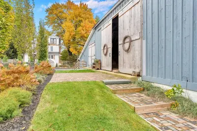 a backyard with a lawn and a building at Underground Railroad 3 Bedroom Farmhouse in Kennett Square
