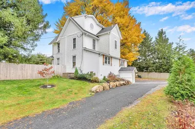 a white house with a fence and a driveway at Underground Railroad 3 Bedroom Farmhouse in Kennett Square