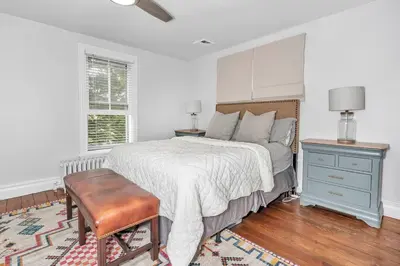 a bedroom with a bed and a table and a chair at Underground Railroad 3 Bedroom Farmhouse in Kennett Square