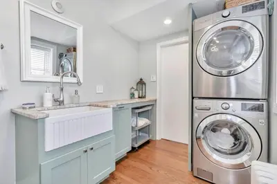a kitchen with a washing machine and a sink at Underground Railroad 3 Bedroom Farmhouse in Kennett Square