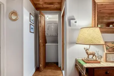 a lamp on a table in a hallway with a refrigerator at Lakeview Retreat in Lakeville