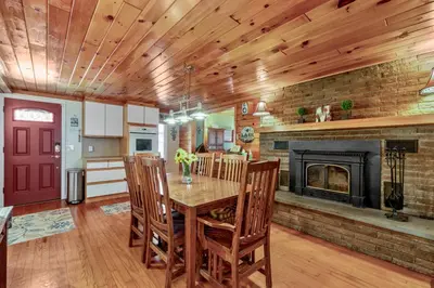 a dining room with a table and a fireplace at Lakeview Retreat in Lakeville