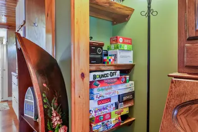 a stack of books on a book shelf at Lakeview Retreat in Lakeville