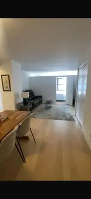 a living room with a table and a couch at Unique Place in midtown NYC in New York