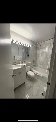 a bathroom with a toilet and a sink and a tub at Unique Place in midtown NYC in New York