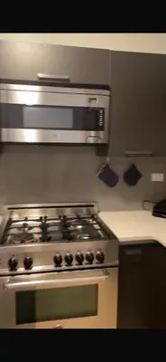 a kitchen with a stainless steel stove top oven at Unique Place in midtown NYC in New York